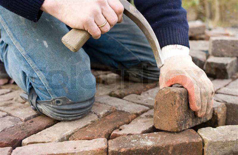 Man at work paving stones, stock photo
