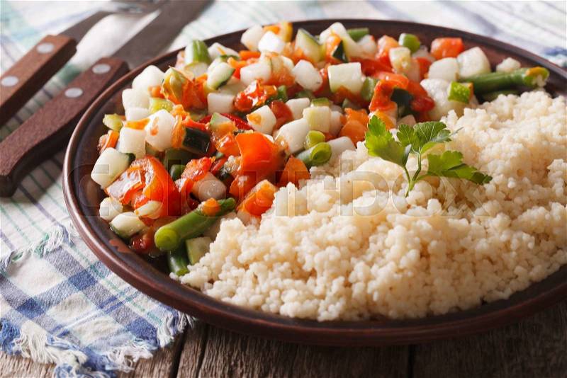 Vegan couscous with vegetable salad on a plate closeup. horizontal , stock photo