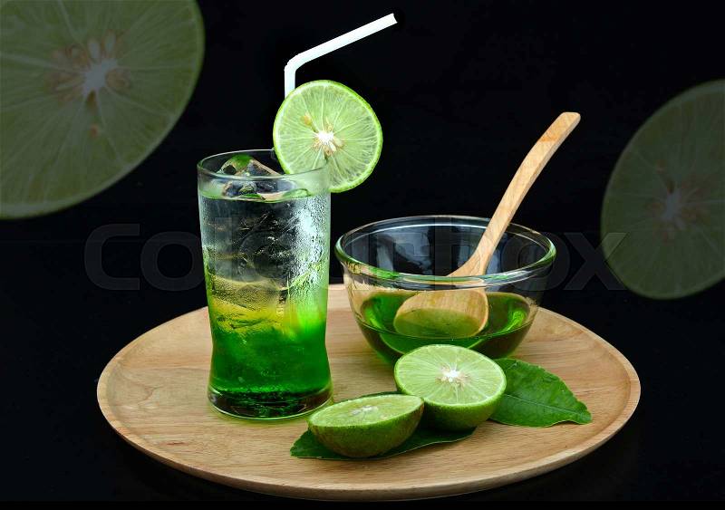 Serve cold drink fresh green lemon syrup on ice, stock photo