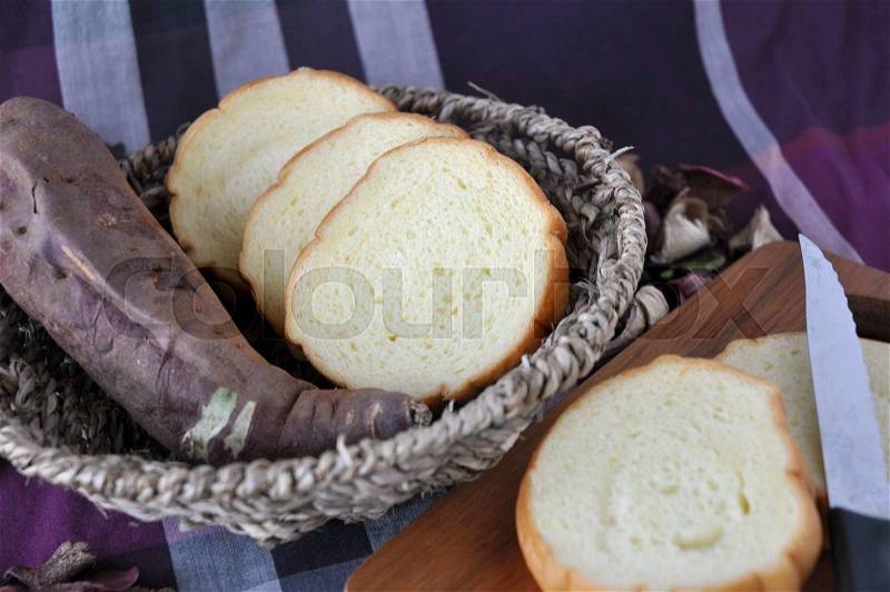 Basket of sweet potato bread with fresh sweet potato, stock photo