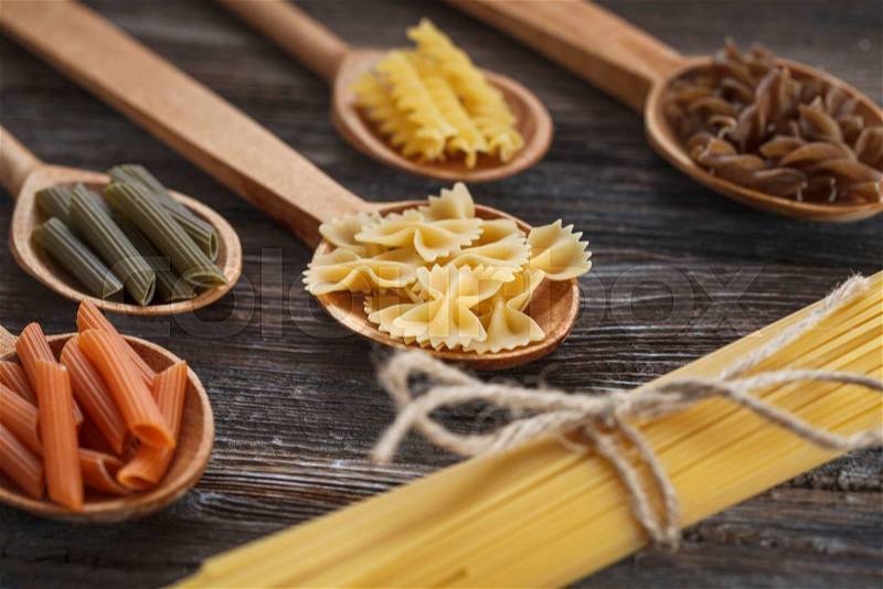 A set of raw pasta on a wooden table. Studio Shot, stock photo