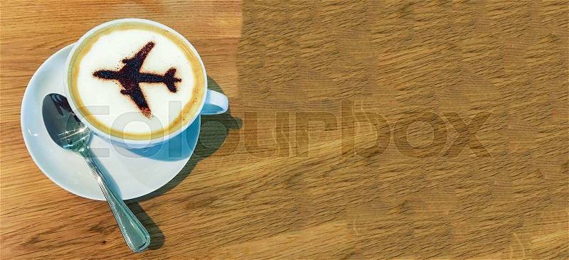 Cup of Coffee with airplane sign on foam, stock photo