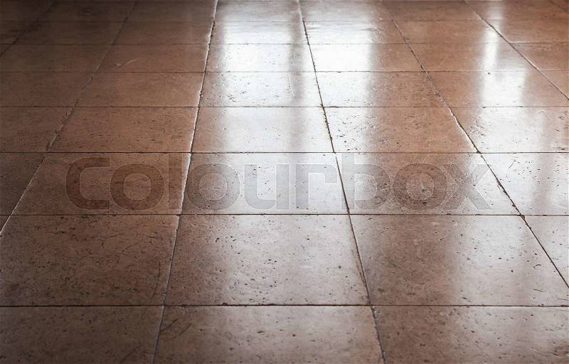 Shining brown stone floor tiling, background texture with perspective effect, stock photo