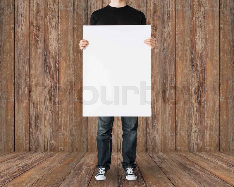 People and advertisement concept - close up of man holding big blank white board over wooden background, stock photo