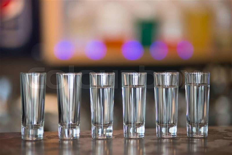Empty and full glasses ready for use in the bar, stock photo