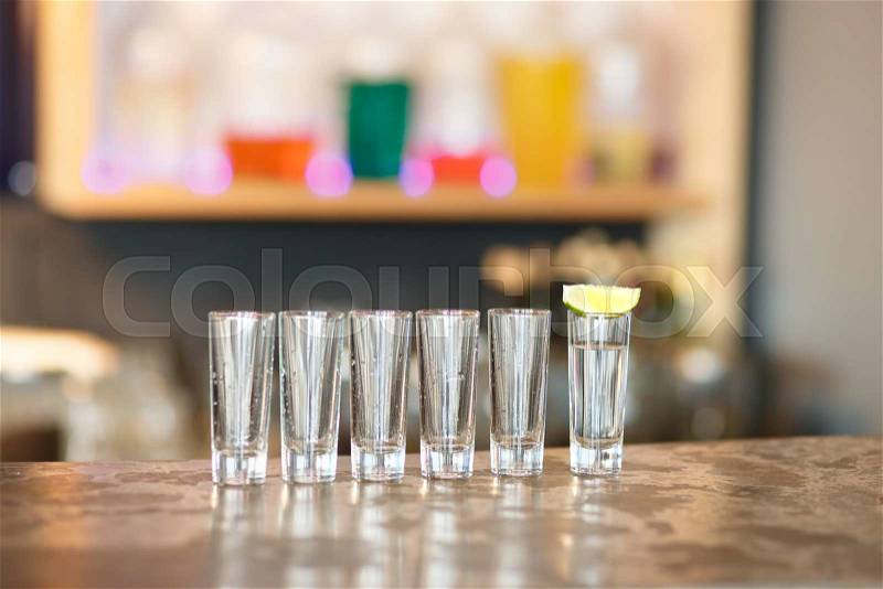 Empty and full glasses ready for use in the bar, stock photo