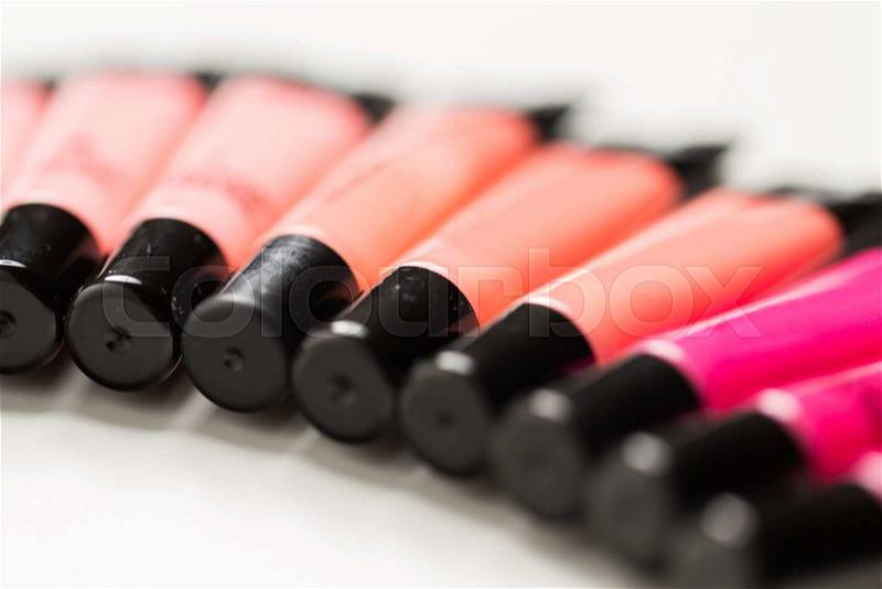 Cosmetics, make up and beauty concept - close up of lip gloss tubes, stock photo