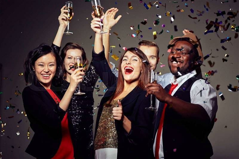 Joyful people toasting with champagne at party, stock photo