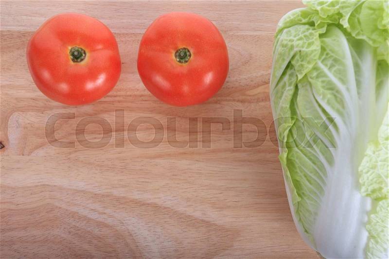 Tomato and cabbage on wooden chopping board prepare cooking, stock photo