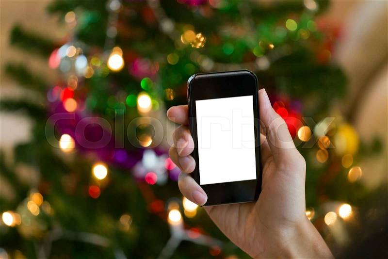 Hand using mobile smart phone with colorful light celebration background, stock photo