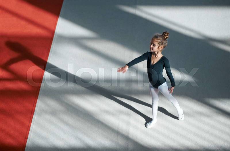 Girl practicing rhythmic gymnastics in the gym, stock photo