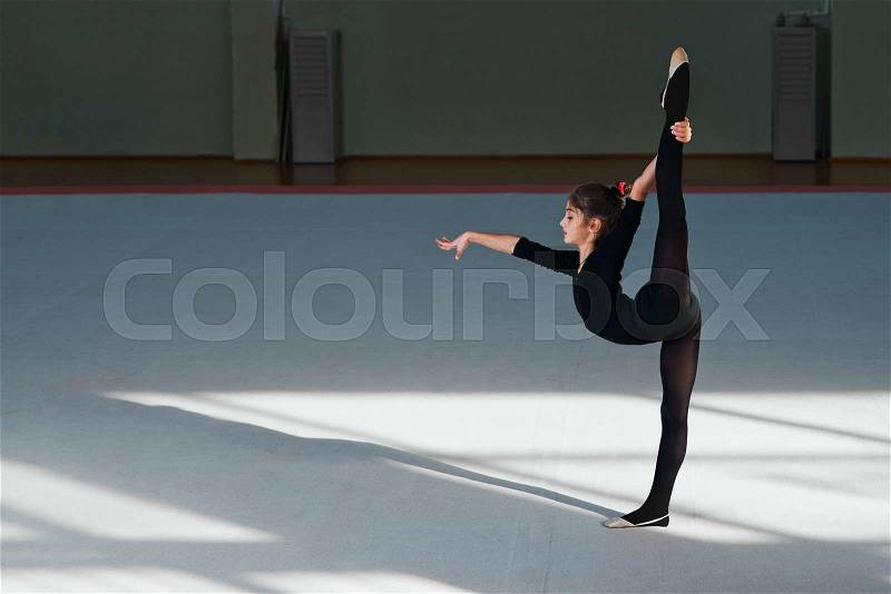 Girl doing the balance in the hall rhythmic gymnastics, stock photo