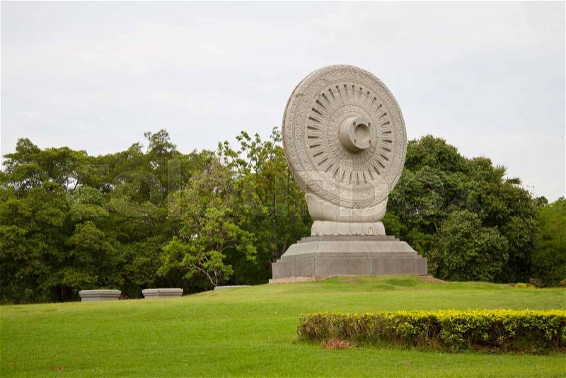 The Wheel of Law in Buddhism made of stone, stock photo