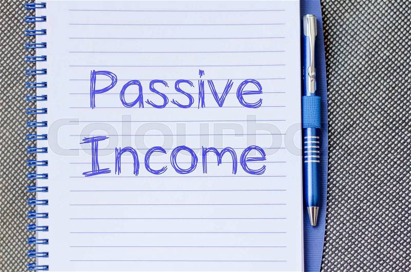 Passive income text concept write on notebook with pen, stock photo