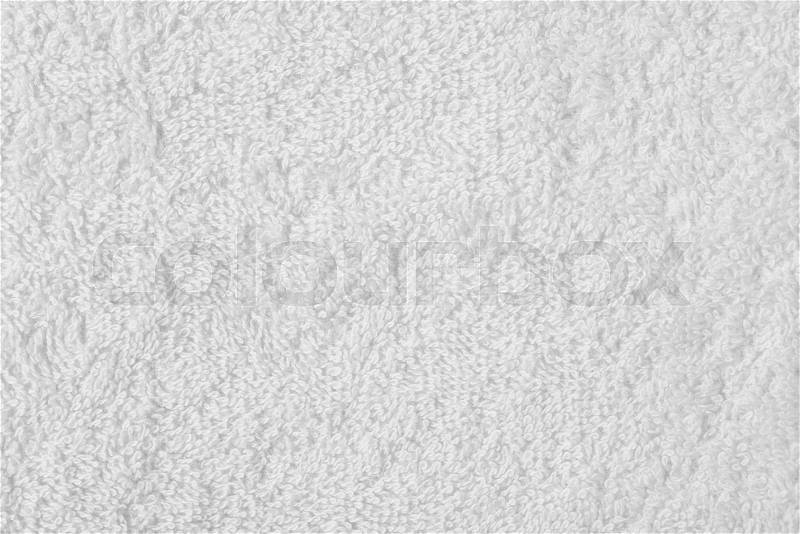 Terry cloth white towel fragment as a background texture, stock photo