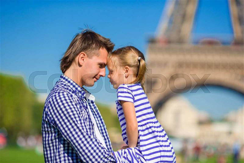 Father and little girl in Paris background Eiffel Tower. French summer holidays, travel and people concept, stock photo