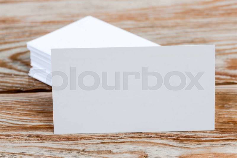 White blank business visit card, gift, ticket, pass, present close up on wooden background. Copy space Blank corporate identity package business card, stock photo