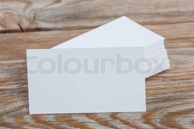 White blank business visit card, gift, ticket, pass, present close up on wooden background. Copy space Blank corporate identity package business card, stock photo