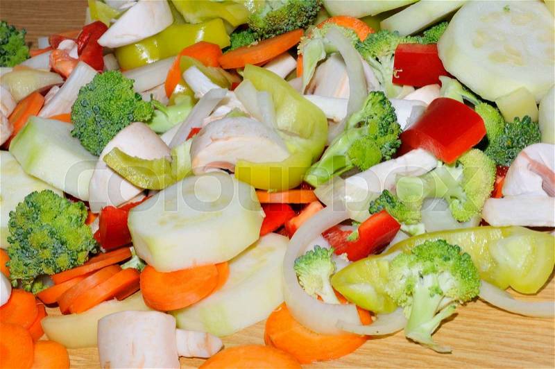 Miscellaneous fresh vegetables cut up in pieces ready for stir fry or saute. It includes carrots, broccoli, onions, asparagus, squash, and red and green pepper for healthy eating , stock photo