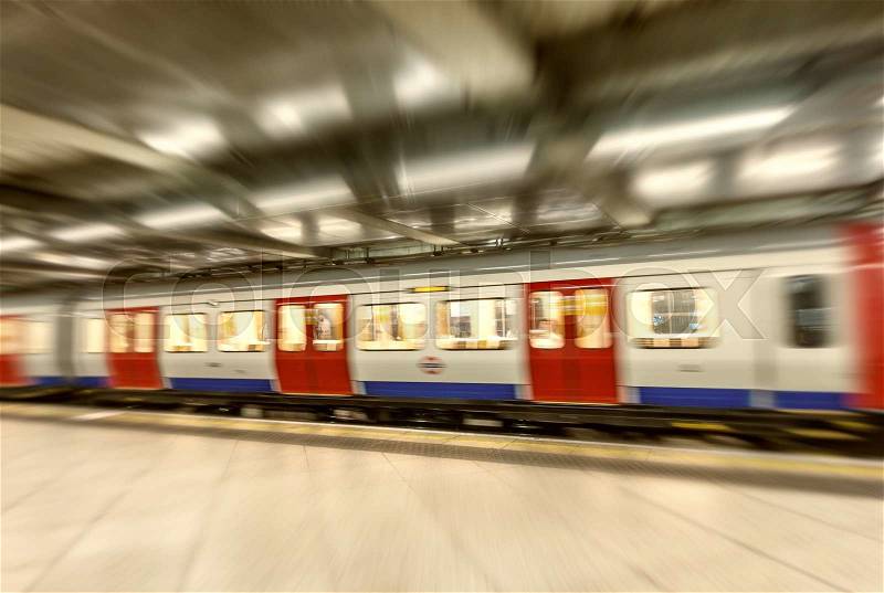 London underground train fast moving in city station, stock photo