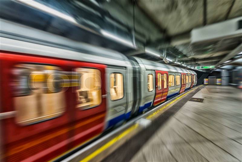 Fast moving subway train in London underground station, stock photo