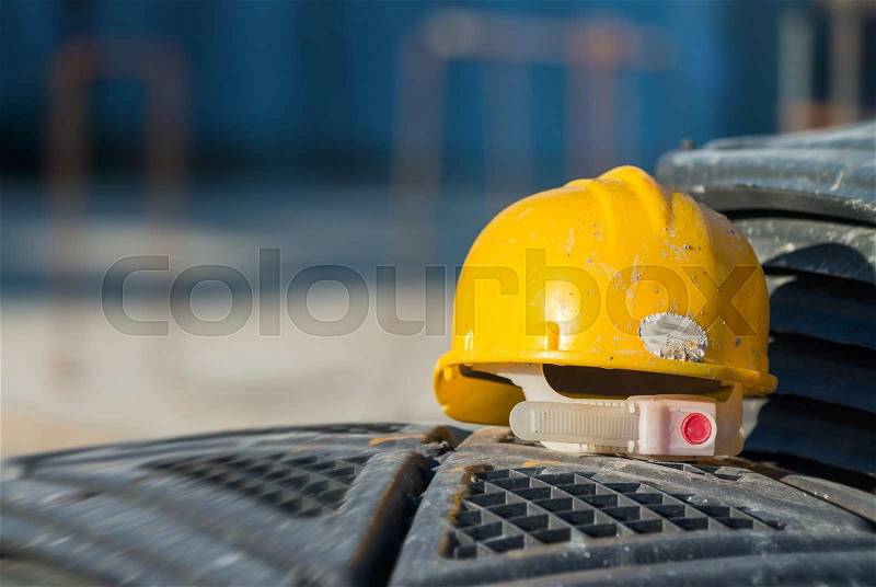 Isolated yellow worker hard-hat,natural light in construction site, stock photo
