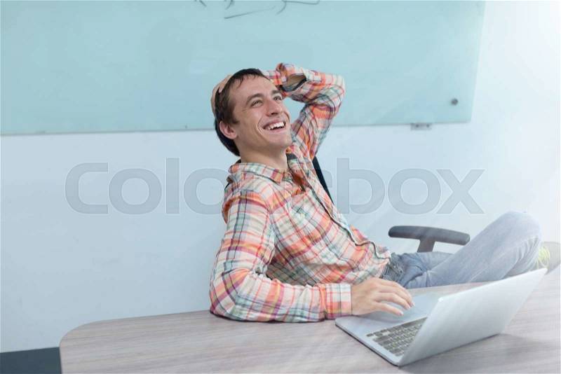 Success excited business man happy smile sitting office desk, young businessman laughing fun, stock photo