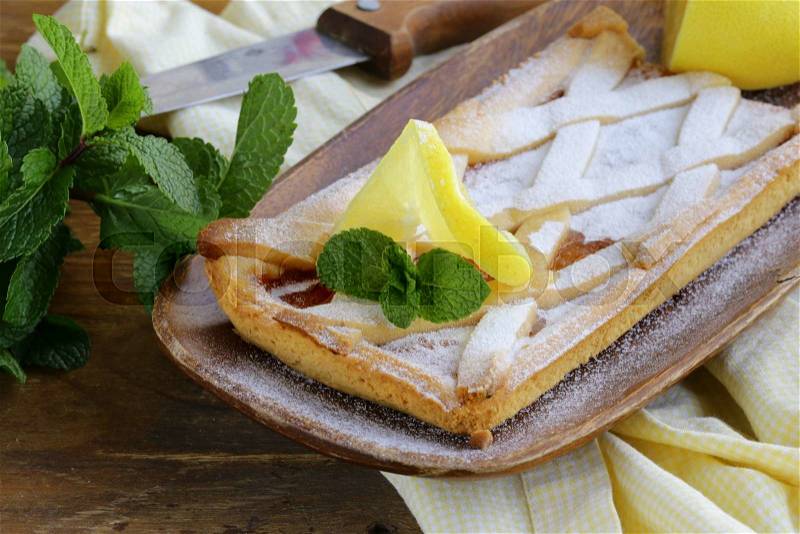 Lemon pie with mint leaves and powdered sugar, stock photo