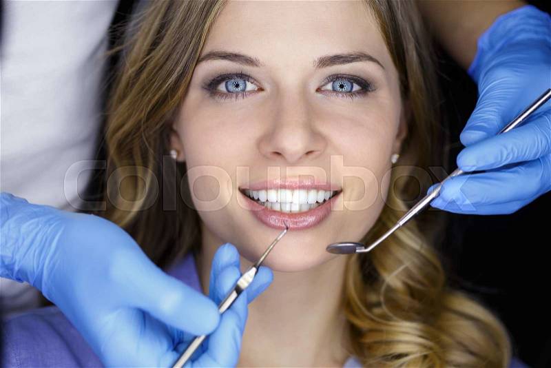 Girl with beautiful white teeth on reception at the doctor dentist, stock photo