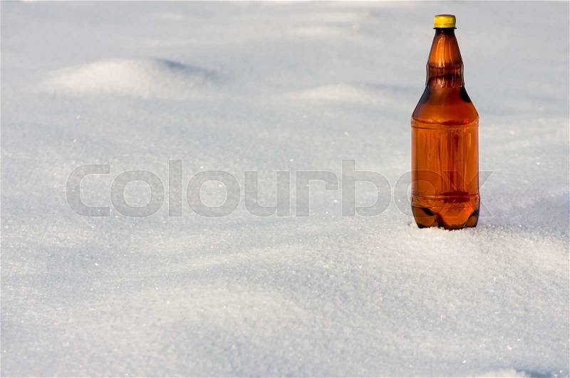 Beer in a plastic bottle in the snow in the winter, stock photo