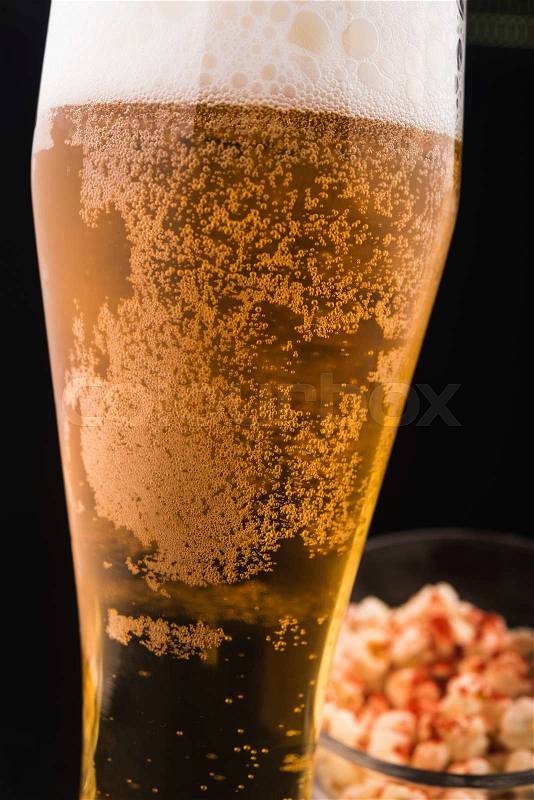 Glass of beer on black background, stock photo