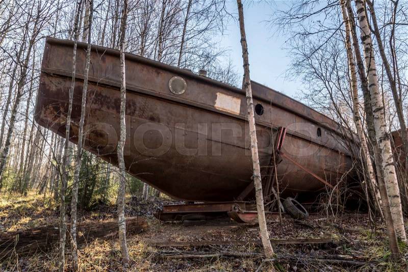 Old Rusy Boat on Land in between birch trees, stock photo