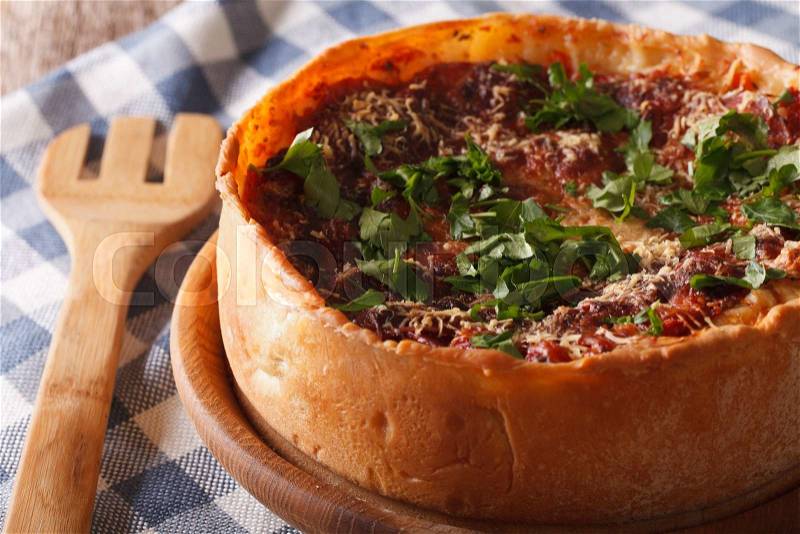Homemade Chicago deep dish pizza closeup on a plate on the table. Horizontal , stock photo