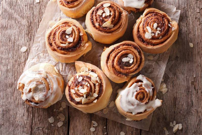 Cinnamon rolls with almond close up on the table. horizontal view from above , stock photo