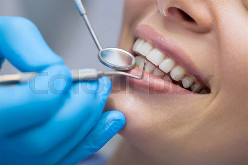 Girl with beautiful white teeth on reception at the doctor dentist, stock photo