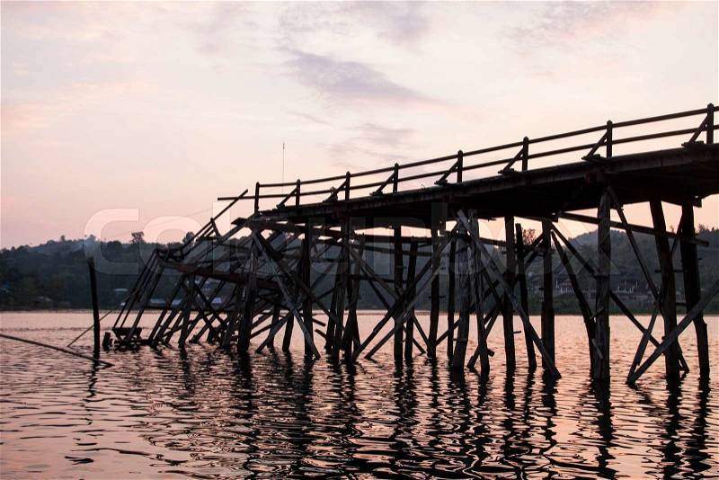 Broken Raman wooden bridge in Sangklaburi, Thailand, stock photo