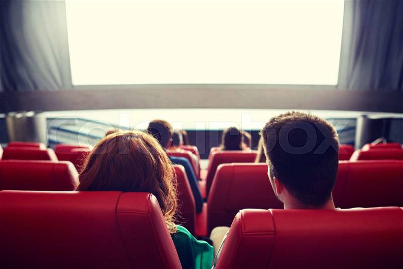 Cinema, entertainment, leisure and people concept - couple watching movie in theater from back, stock photo