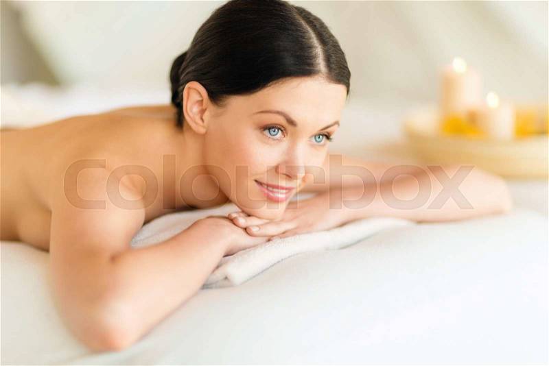 Health and beauty, resort and relaxation concept - woman in spa salon lying on the massage desk, stock photo