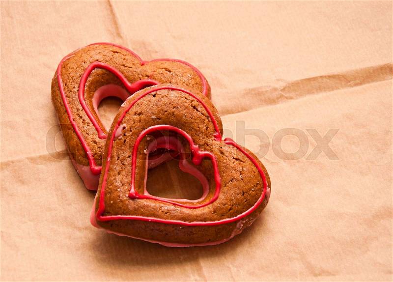 Honey-cakes in shape of heart on paper, love concept, stock photo