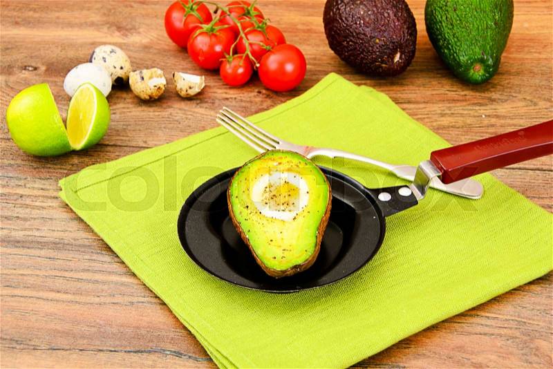 Avocados, baked with quail egg, salt, pepper and lemon Studio Photo, stock photo