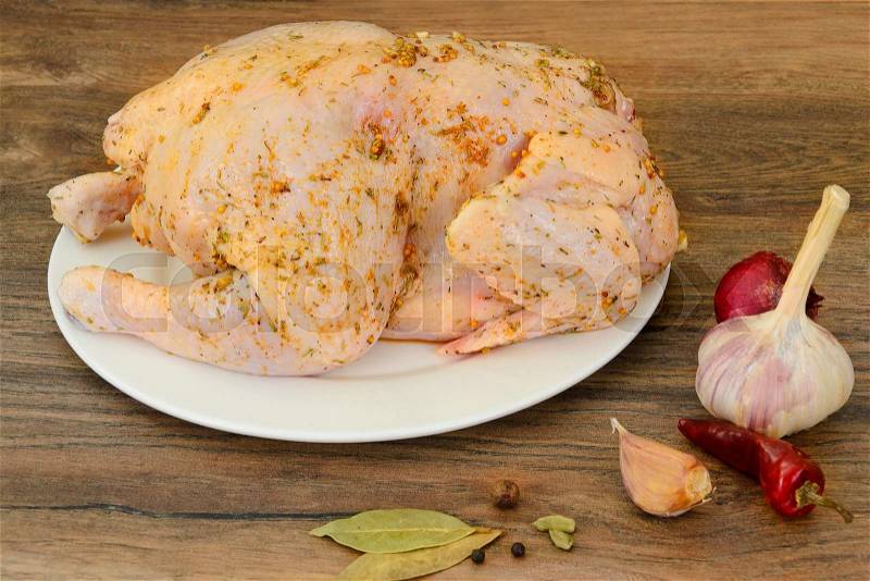 Raw Chicken with Herbs on Wood Background. Studio Photo, stock photo