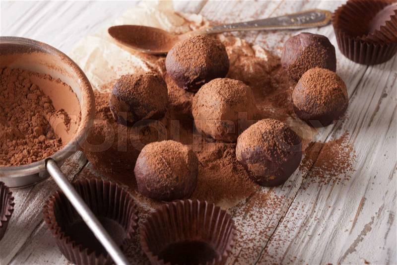Chocolate truffles sprinkled with cocoa powder close-up on the table. horizontal , stock photo