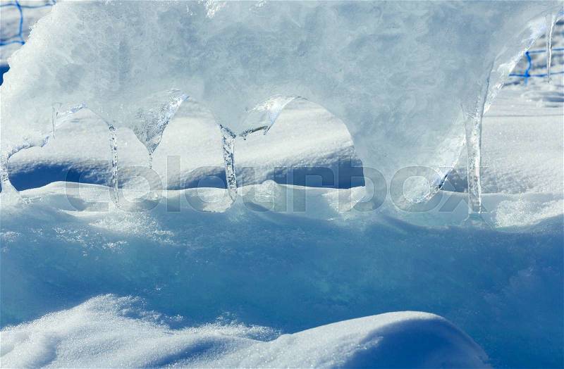 Melting glacial block of ice with icicles closeup, stock photo