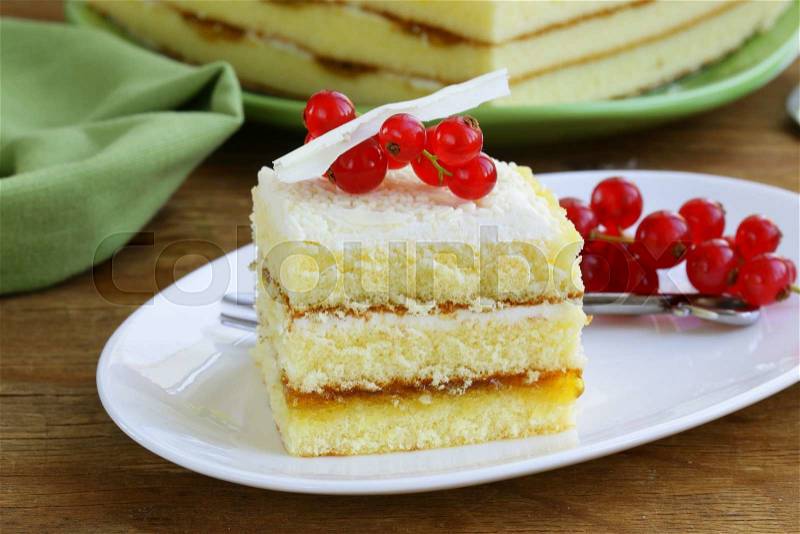 Sponge cake with white chocolate, decorated with red currant, stock photo