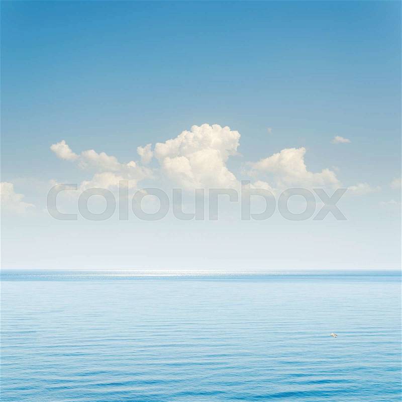 Blue sea and sky with clouds over it, stock photo