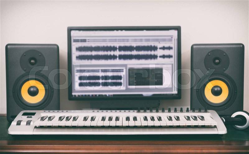 Home recording studio with professional monitors and midi keyboard, stock photo