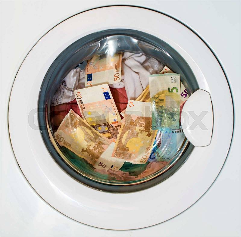 Lots of euros in washing machine. Dirty money concept, stock photo