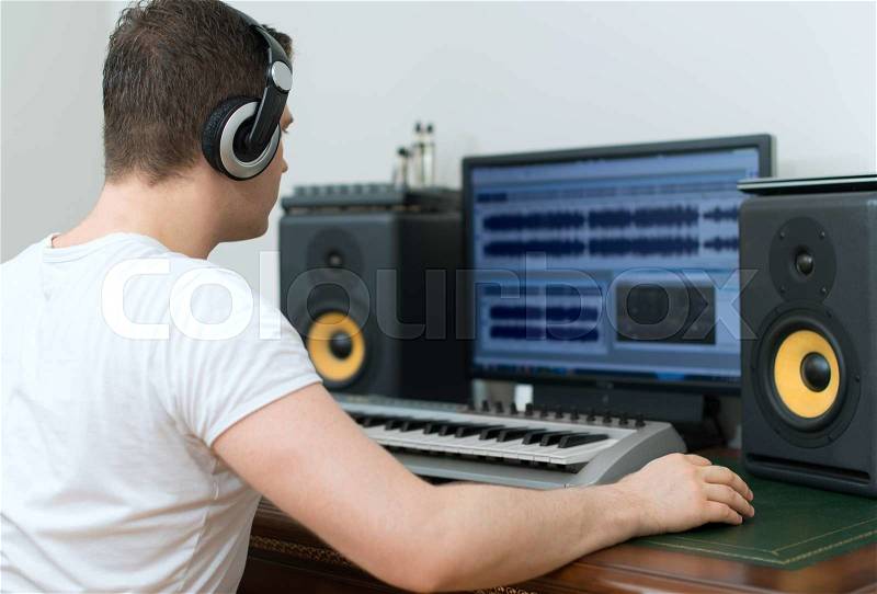 Male sound producer working in recording studio, stock photo
