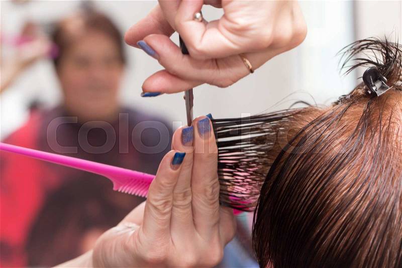 Female hair cutting scissors in a beauty salon, stock photo