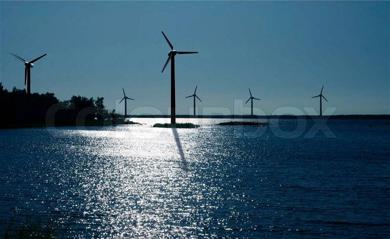 On-shore wind power farm at moonlight, stock photo
